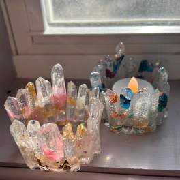 Two glittery crystal candle holders on a windowsill
