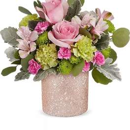 Pink roses and mixed flowers in a glittery pink vase