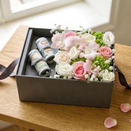 Bouquet of pink, purple, and white flowers with rolled dollar bills