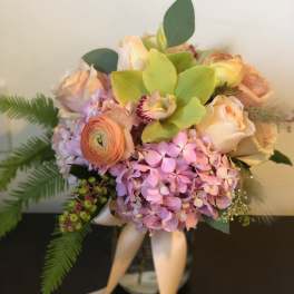 Bouquet of pastel roses, hydrangea, and green orchids with ribbon