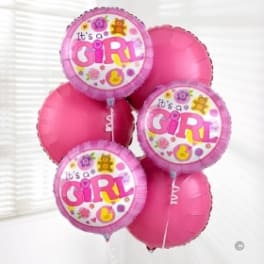 Cluster of pink balloons, three reading "It's a Girl"