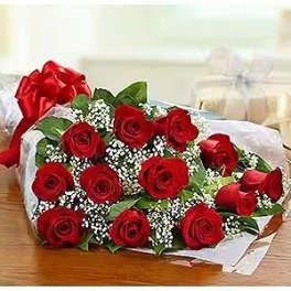 Bouquet of red roses with white filler flowers wrapped in paper