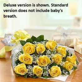Bouquet of yellow roses with baby's breath on a table