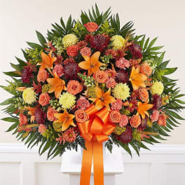 Large orange and coral floral spray with lilies and roses