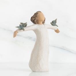 Wooden angel figurine with outstretched arms and blue birds on each shoulder