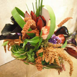 Bouquet with pink roses, black calla lilies, and green succulent accents