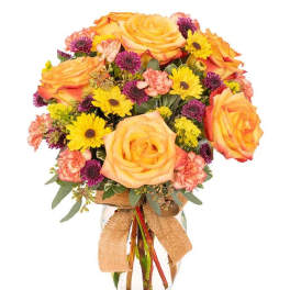 Bouquet of yellow roses, daisies, and pink carnations in a glass vase