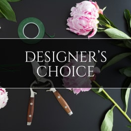 Pink peony blooms with floral tools on a dark background