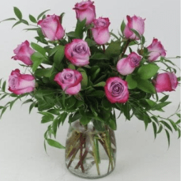 Pink roses arranged in a clear glass vase