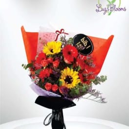 Bouquet of red and yellow flowers wrapped in orange paper