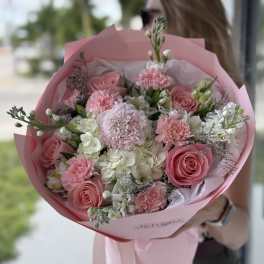 Pink rose and carnation bouquet wrapped in pink paper