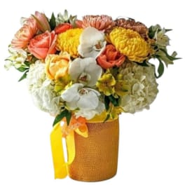 Mixed bouquet in a burlap-wrapped vase with yellow ribbon
