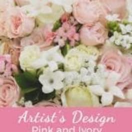 Pink and white roses arranged in a floral display