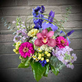 Colorful bouquet with orchids, zinnias, and mixed blooms