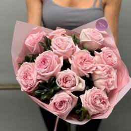 Bouquet of pale pink roses wrapped in pink paper