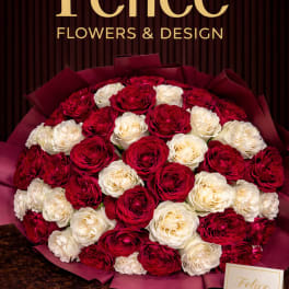 Bouquet of red and white roses wrapped in burgundy paper
