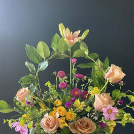 Mixed bouquet with peach roses, lilies, and pink daisies