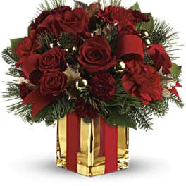 Red roses in a gold gift box with ribbon and holiday accents