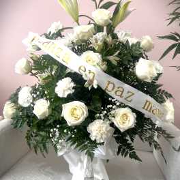 White rose and lily arrangement with a condolence ribbon