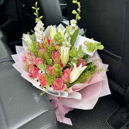 Pink rose bouquet with white lilies and a birthday topper