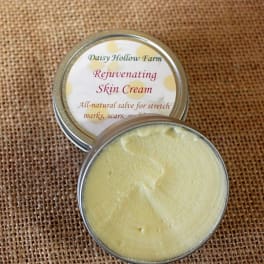 Two tins of skin cream on burlap fabric
