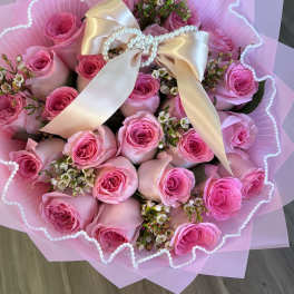 Pink rose bouquet with a satin bow and pearl accents