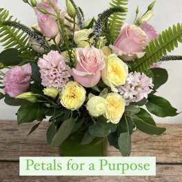Pink and yellow mixed bouquet in a green vase