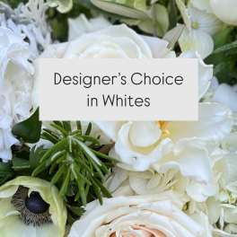 White floral arrangement with roses and mixed blooms