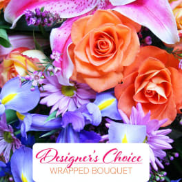 Mixed bouquet of orange roses, pink lilies, and purple flowers