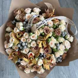 Large bouquet of blush and cream roses with orchids and ribbon