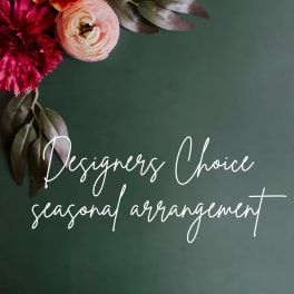 Floral arrangement with orange, pink, and magenta blooms on a dark green background