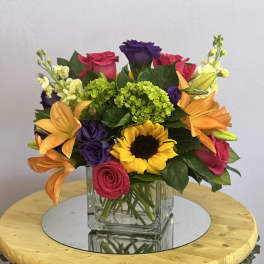 Colorful mixed bouquet in a square glass vase
