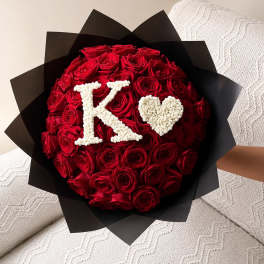 Red rose bouquet with a white K and heart on black wrap