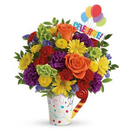 Colorful bouquet in a party cup with balloons and a "Celebrate!" sign