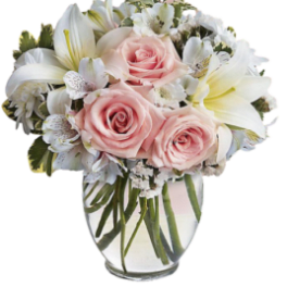 Pink roses and white lilies in a clear glass vase