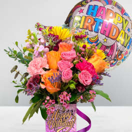 Colorful birthday bouquet with roses and a balloon