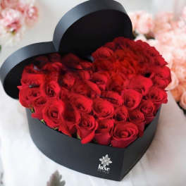 Heart-shaped box filled with red roses