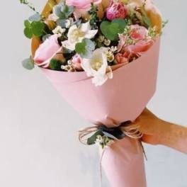 Pink and white bouquet wrapped in pastel paper