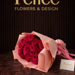 Bouquet of hot pink roses wrapped in pale pink paper
