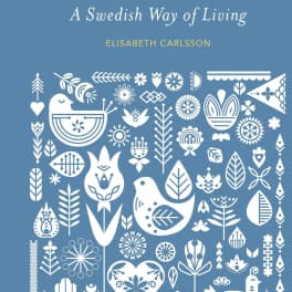 Blue book cover with white folk-art birds and floral motifs