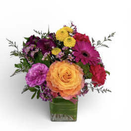 Colorful mixed bouquet in a square glass vase