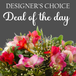 Mixed bouquet of pink and red flowers with greenery