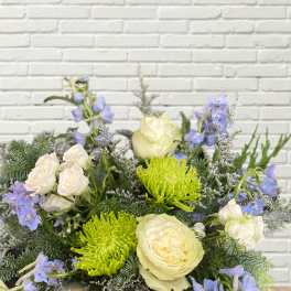 Bouquet of white roses, green spider mums, and blue flowers