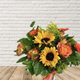 Bouquet of sunflowers and orange roses in a vase