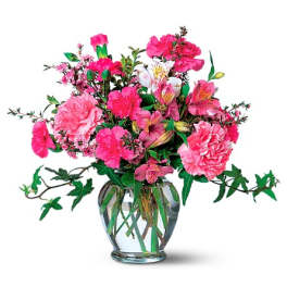Pink mixed bouquet in a clear glass vase with trailing ivy