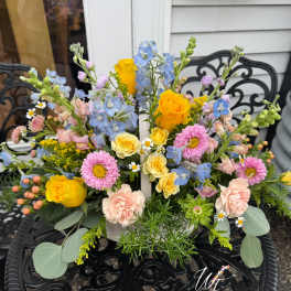 Mixed bouquet with yellow roses, pink daisies, and blue flowers