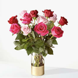 Bouquet of pink and red roses in a clear glass vase