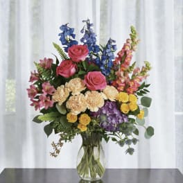 Colorful mixed bouquet in a clear glass vase