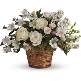 Low basket arrangement of white roses, alstroemeria, and soft pink spray roses