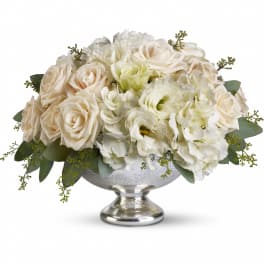 Low white and cream rose and hydrangea arrangement in a silver pedestal bowl